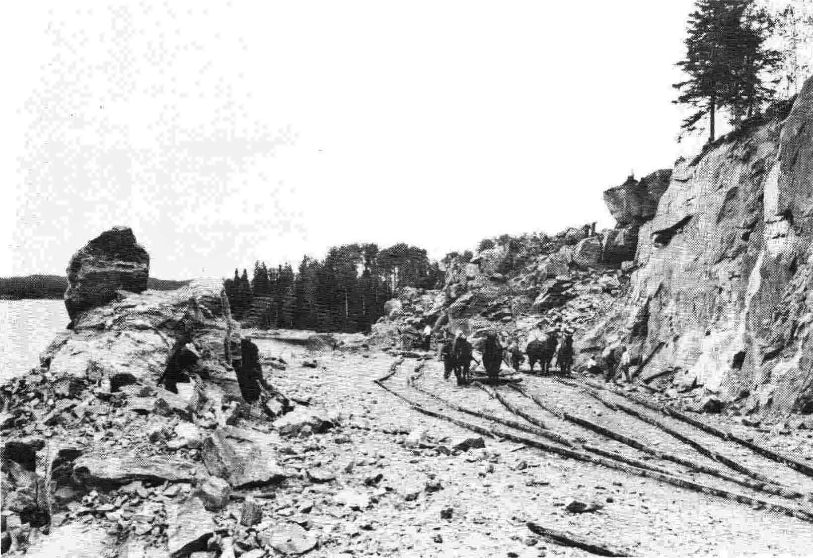 "Horses were used on this section of road along Muncho Lake to haul away the blasted rock."